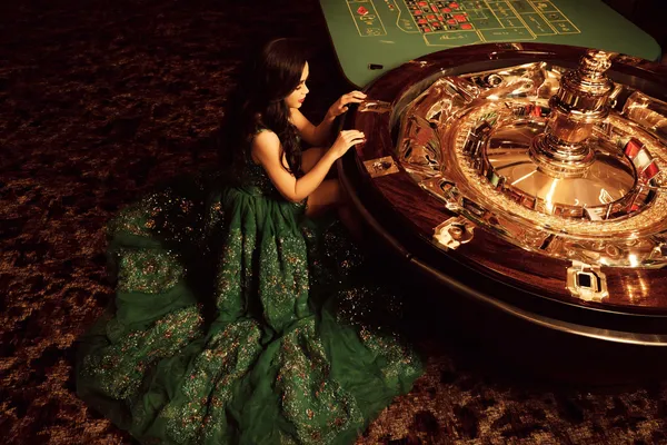 A glamorous woman holding casino chips in a neon-lit environment, representing the premium online casino atmosphere of BET786.